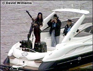 Maria Cuccinotta with a gun on the back of a boat