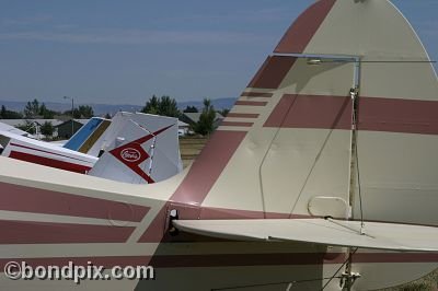 Tail fins of multiple aircraft at the annual fly in at Pogreba Field, Three Forks, Montana