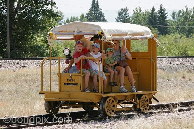 0817.jpg - A happy family takes a ride on a railroad speeder along the old Milwaukee Road