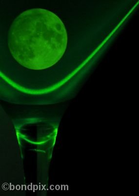 Green moon in a glass lit by laser