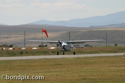 A Cesnna taxis past the windsock at the annual fly in at Pogreba Field, Three Forks, Montana