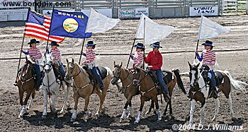 The Charlie Russell Riders parade flags