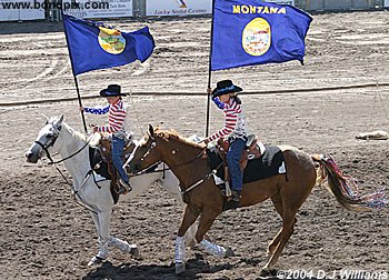 The Charlie Russell Riders parade the Montana flag on horseback